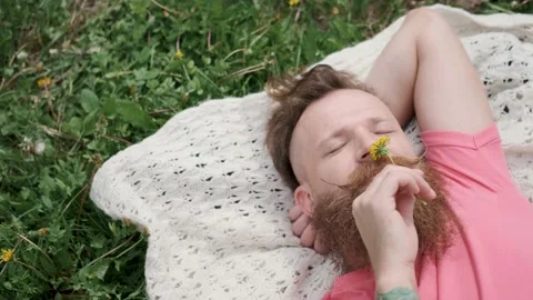 Man with dandelion is lying in meadow on grass,good mood,sunny summer weather Stock Footage 131304844