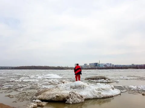 A man in danger on an ice floe during ice drift. Stock Photos