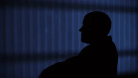Man on a dark background turns in profile Stock Footage 146958029