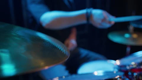 A man in dark clothes plays drums on stage before a concert Stock Footage 240903085