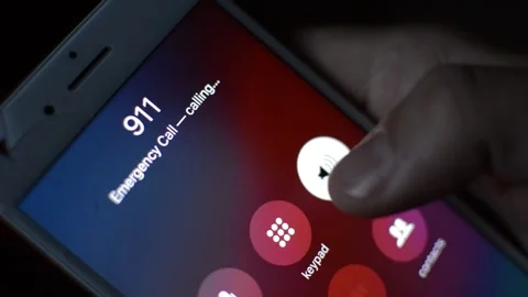 Man in the dark dial and call 911 emergency number on his iphone by apple. Video stock 238784100