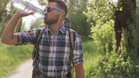 Man With Dark Glasses Drinking Water From the Bottle Stock Footage 77672516