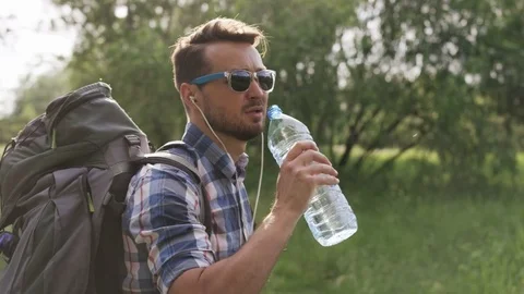 Man With Dark Glasses Drinking Water From the Bottle Stock Footage 77672712