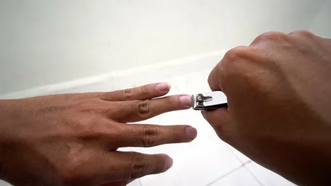 A man with dark hand cut the fingernails Stock Footage 197011386
