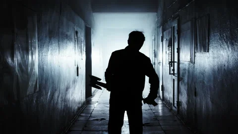 A man in a dark room strikes with an ax Stock-Footage 166995260