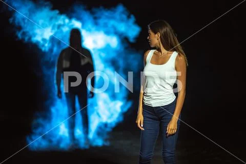 The man in the dark street following the woman Stock Photos