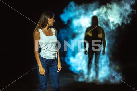 The man in the dark street following the woman Stock Photos
