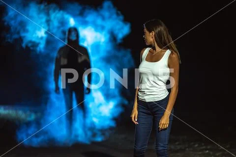 The man in the dark street following the woman Stock Photos