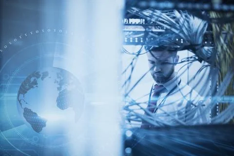 Man in a data center against digital earth background Foto stock
