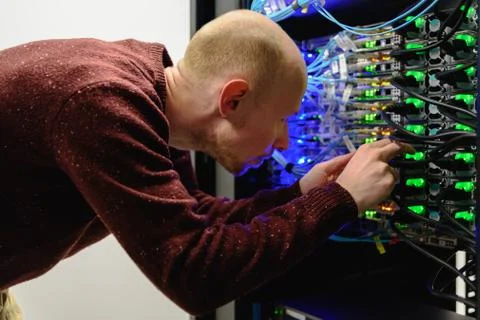 Man data center technician performing server maintenance Stock Photos