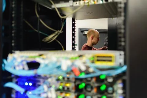 Man data center technician performing server maintenance Stock Photos