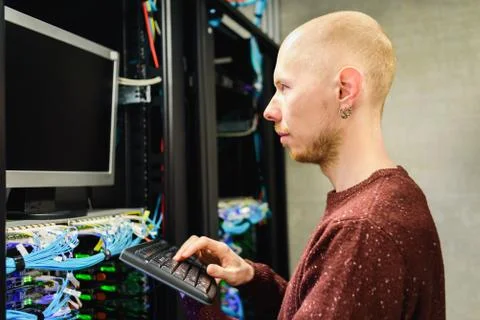 Man data center technician performing server maintenance Stock Photos
