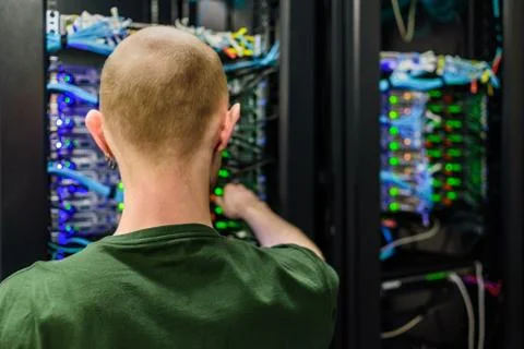 Man data center technician performing server maintenance Stock Photos