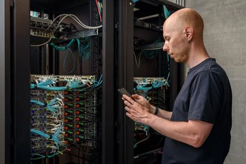 Man data center technician performing server maintenance Stock Photos