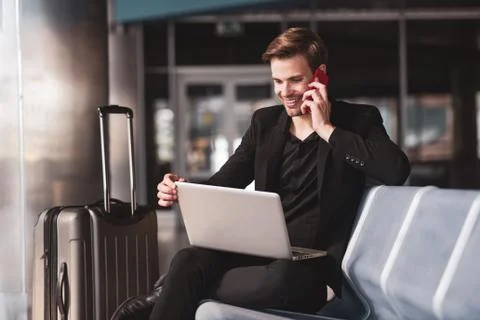 Man dealing with his working tasks in the airport Stock Photos