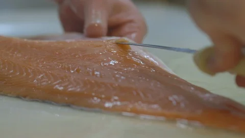 Man deboning a salmon fillet Stock Footage 104867971