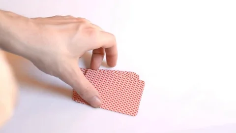 A man decodes playing cards on a white background. close-up. Four nines. Stock Footage 73897546