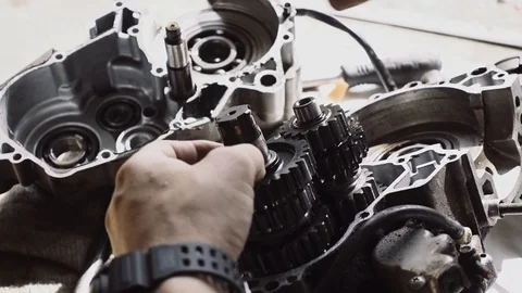 Man deconstructs motor Stock Footage 96025874