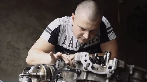 Man deconstructs motor Stock Footage 96025881