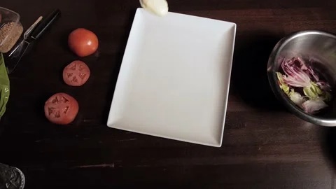 A man decorates a dish. Puts the sauce on a plate and spread it in a thin strip Stock Footage 136056461