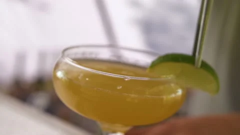 A man decorates a glass with a slice of lime. Stock Footage 235541274