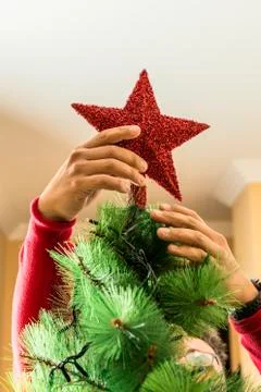 Man decorating a Christmas tree. Stock Photos
