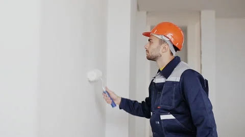 Man decorating room. painting wall with paint roller Stock Footage