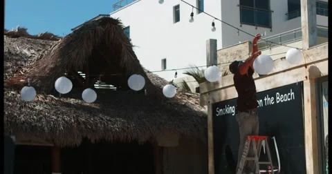 Man decorating wedding at the beach Stock Footage 47510961