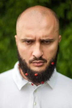 Man with decoration in beard Stock Photos