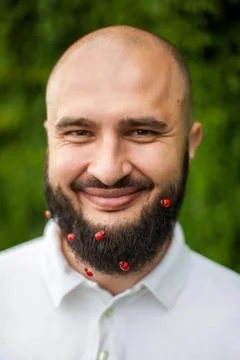 Man with decoration in beard Stock Photos
