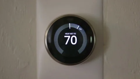 Man Decreasing Temperature of Smart Thermostat Gadget At Home Video stock 75252407