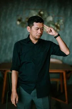 Man deep in thought, Portrait of a contemplating businessman indoors 写真素材