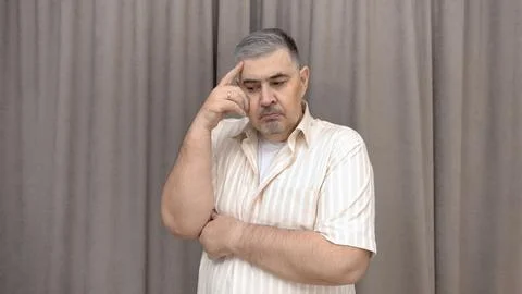 A man deep in thought. Reflections, decision making, doubts. Stock Photos