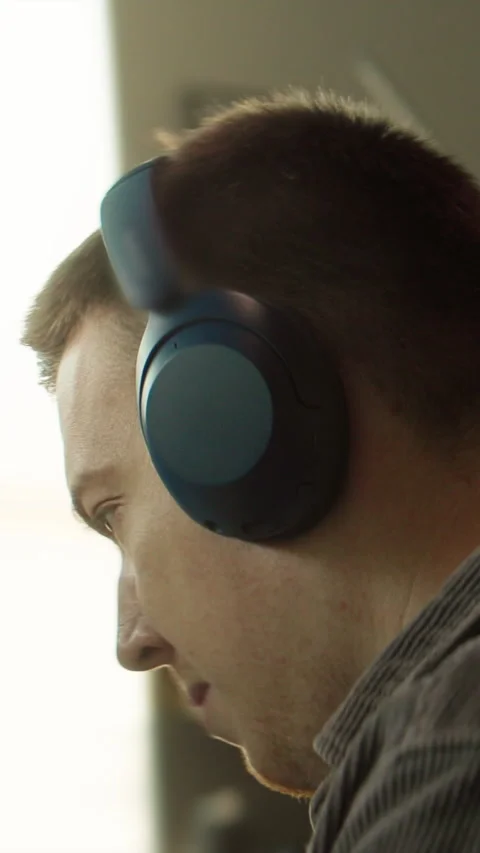 A man in deep thought, serious, wearing headphones, focused and contemplative Stock Footage 319606259