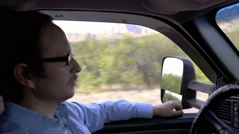 A man in deep thought while driving on a country road Stock Footage 240005828