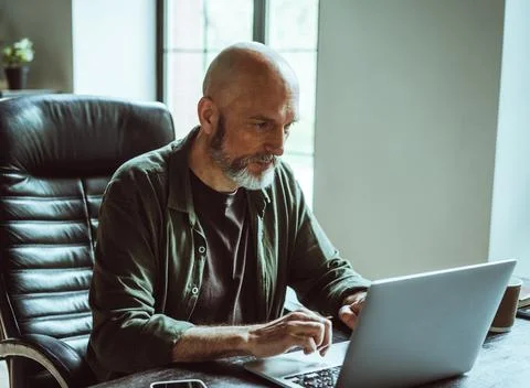 Man deeply concentrated on work as freelancer. With unwavering focus and passion Stock Photos