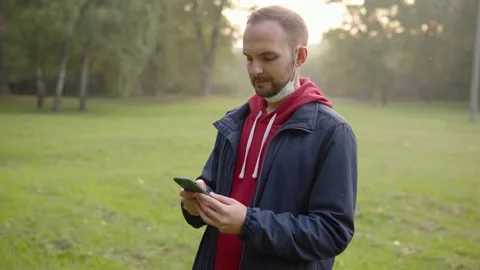 A man with a deflated mask chats in messenger and then puts on a mask and goes Stock Footage 161474792