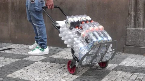 Man delivering drinks in bottles by a hand cart Stock Footage 159016171