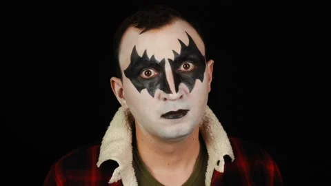 Man in demon makeup with crazy look on black background Stock Footage 146578439