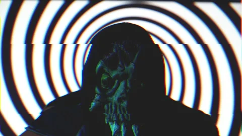 Man with demonic mask against monochromatic rotating spiral Seamless Loop Stock Footage 222909757