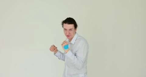 Man demonstrates basic striking self-defense techniques against white background Stock Footage 290844835