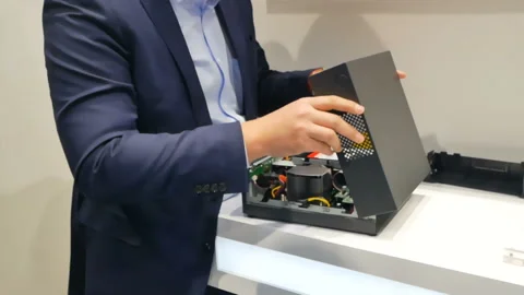 A man demonstrates the computer system unit of commercial equipment Stock Footage 86634295