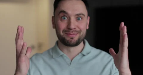Man demonstrates expresses a range of positive emotions, surprise and happiness Stock Footage 302273330