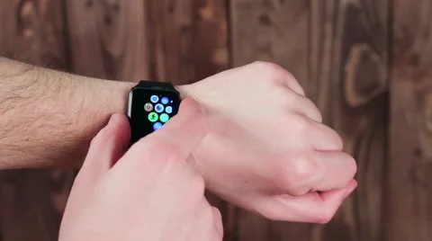 Man Demonstrates the Features of Smart Watches in His Hand. Modern Video stock 61179393