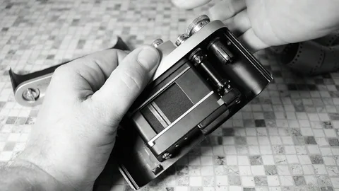 Man demonstrates the shutter of a film camera Stock Footage 122625701