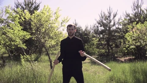 A man demonstrates the skill of kung fu with the two sticks Stock Footage 132469905