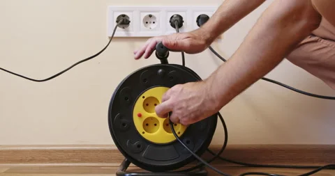 Man demonstrates usage of extension socket on cable hank 스톡 동영상 258503443