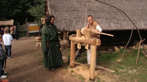 Man demonstrates work on the traditional turning lathe in Biskupin, Poland. Stock Footage 58658366