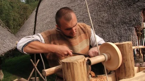 Man demonstrates work on the traditional turning lathe in Biskupin, Poland. Stock Footage 58658368