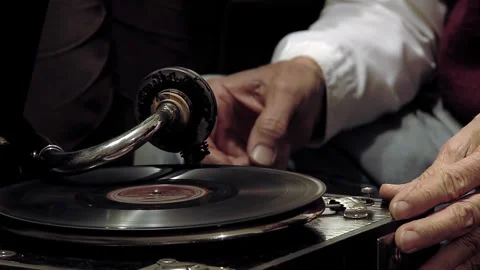 Man Demonstrating How to Operate an Antique Gramophone With Hand Crank - 4K Stock Footage 336685749